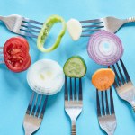 Sliced pieces of fresh vegetables on the forks