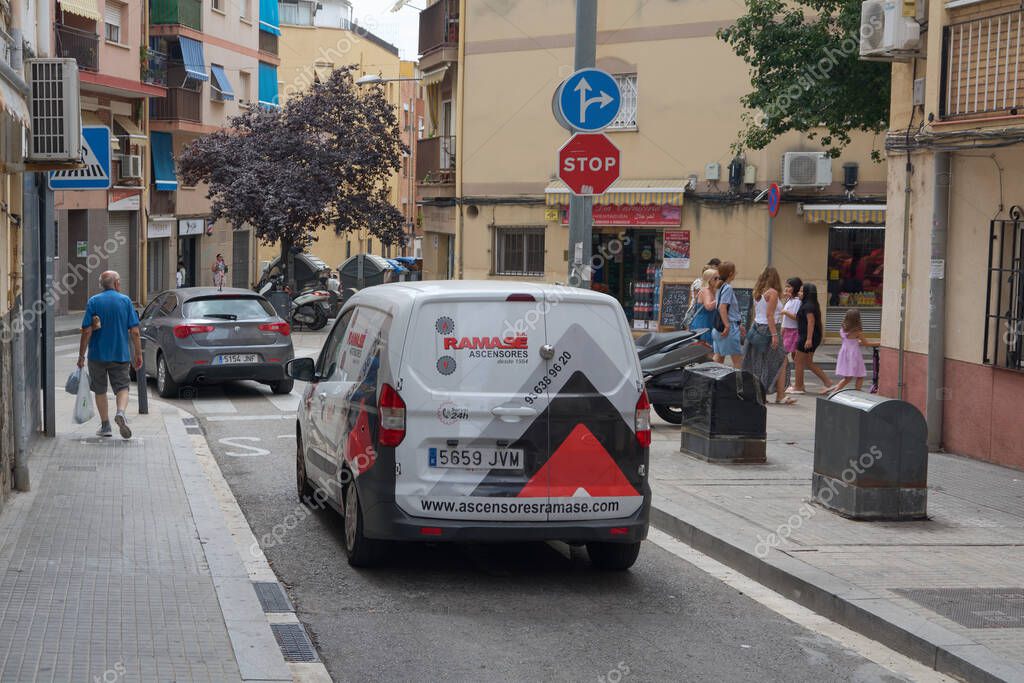 Viladecans. Barcelona - September 05, 2025: A service van from the company Ramase Ascensores parked on a narrow street, displaying its distinctive logo and contact information.