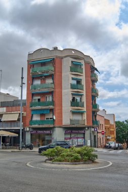 Viladecanlar. Barcelona - Eylül 05, 2025: Gri renkli bir Cupra Formentor arabası, tuğladan bir apartmanın önündeki kavşağın etrafında dönüyor..