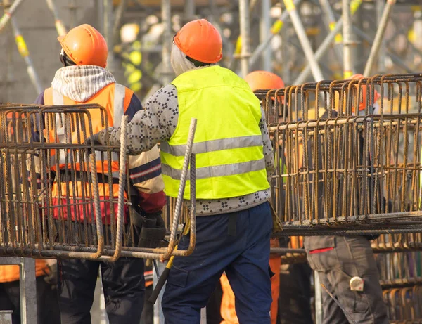 Dois trabalhadores em chapéu laranja na área de reconstrução — Fotografia de Stock
