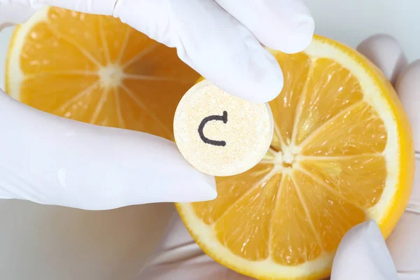 Enfermeira é segurar comprimido de vitamina c e limão fresco — Fotografia de Stock