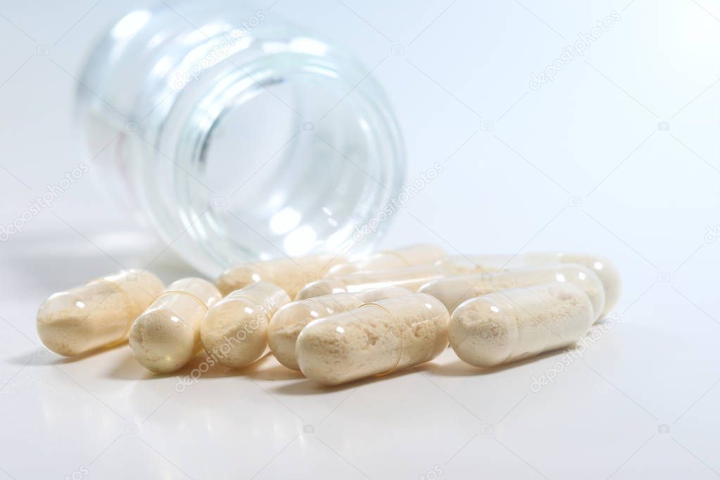 Bunch of transparent Antibiotics capsules and glass bottle