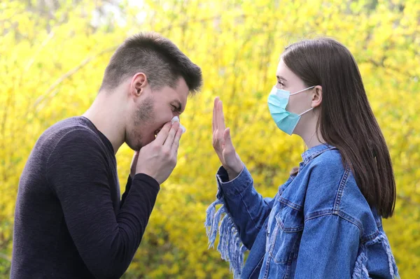Girl with protective mask and sick sneezing boy, stop the flu  e — Stock Photo, Image