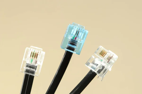 Three lan cables with blue and white rj-45 connector on white — Stock Photo, Image