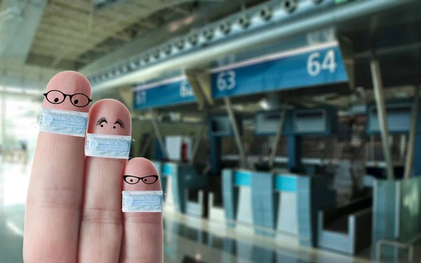 Finger face family with masks in airport, covid19 virus outbreak