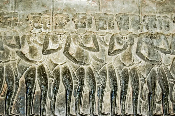 Bas relief carving of Hindus waiting to be sent to either one of the religions 37 heavens or 32 hells. Southern Gallery, east section Angkor Wat temple, Siem Reap, Cambodia.