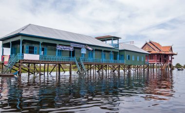 Kampong Phluk, Kamboçya - 4 Aralık 2011: Kamboçya 'nın Tonle Sap gölündeki barakalar üzerine kurulmuş belediye okulu ve balıkçılık bürosu.