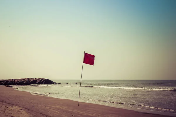 Red flag on the ocean. Warning red flag