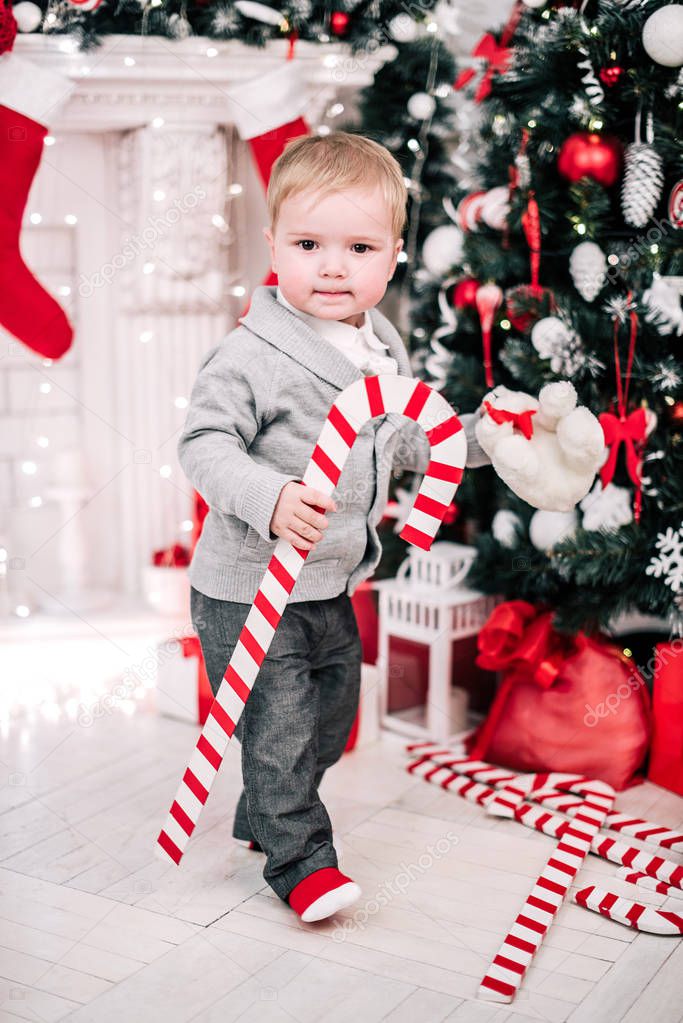 Christmas portrait of a young boy cozy atmosphere around the fireplace and Christmas tree