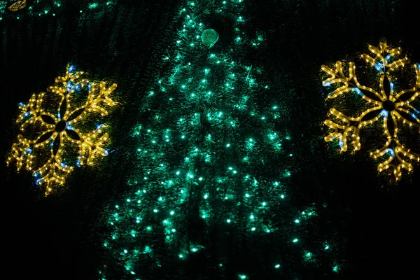 Close up of large Christmas tree with bright garlands