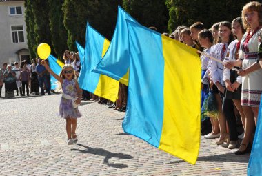 Chortkiv - Ternopil - Ukrayna - 31 Ağustos 2017. Ukrayna Devlet bayrakları çerçevede topuyla kutlamalar sırasında Devlet Pedagoji üniversitede çalışan küçük bir kız 