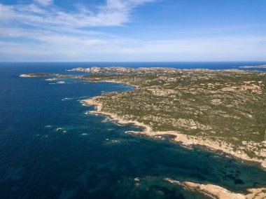 Drone aerial perspective over the archipel of La Maddalena, located north from sardinia, italy. Amazing summer landscape with rocky environment and turquoise crystal clear sea. clipart