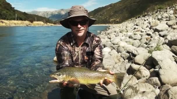 Fly Fisherman Poses Large Live New Zealand Brown Trout Prior — Stock Video