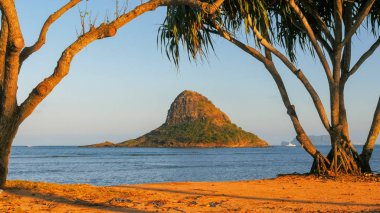 Chinamans hat near kualoa beach park at sunset clipart