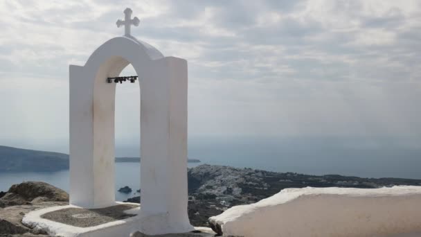 Shot van een kruis met uitzicht op Oia op Santorini — Stockvideo