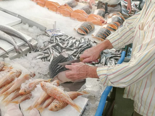 Een visboer snijdt een vis op de centrale markt van Athene — Stockfoto