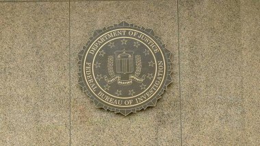 close up of the seal of the fbi on the outside of the fbi building in washington clipart