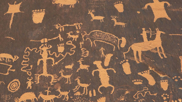shot of an american indian art petroglyph of a hunting scene on newspape