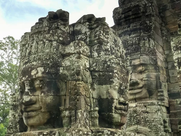 carved stone face towers at bayon temple