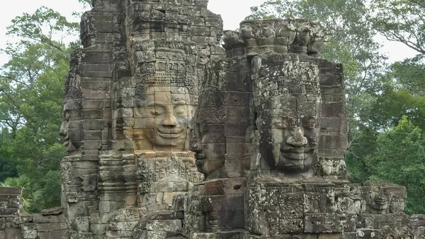 four large carved stone faces at bayon temple