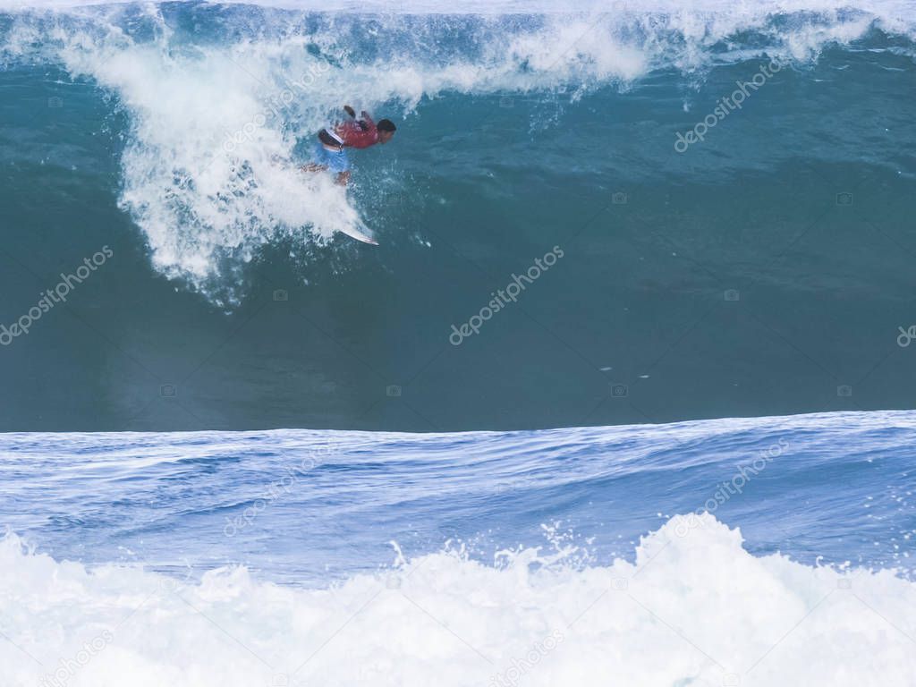 surfer getting a tube ride at pipeline, hawaii