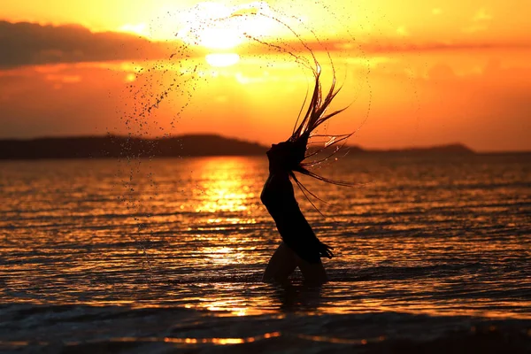 若い女の子が夕日の間に写真をポーズ — ストック写真