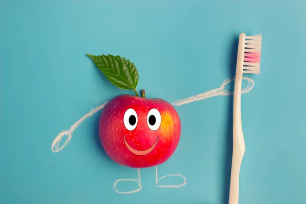 apple character holding a toothbrush on blue background