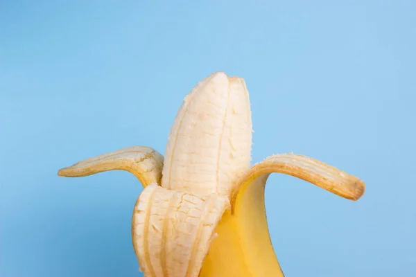 open banana on blue background. close up