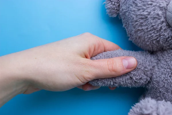 Mãos Menina Segurando Ursinho Pelúcia Fundo Azul — Fotografia de Stock