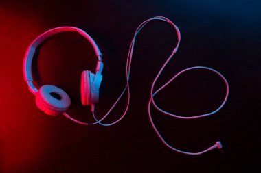 Karanlık arka plandaki kulaklıklar neon ışıklarıyla