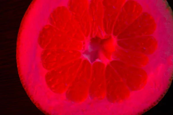 Slice Grapefruit Neon Red Backlit Black Background — Stock Photo, Image
