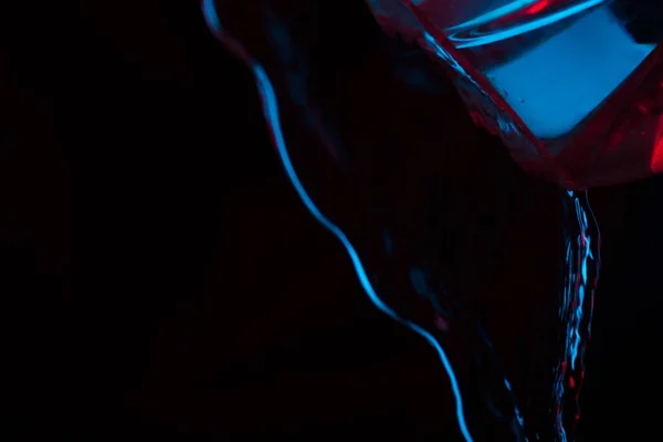 Red and blue neon background from water flow. defocused