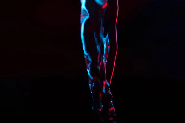 Red and blue neon background from water flow. defocused