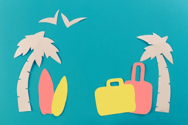 suitcase on the beach with palms. paper cut