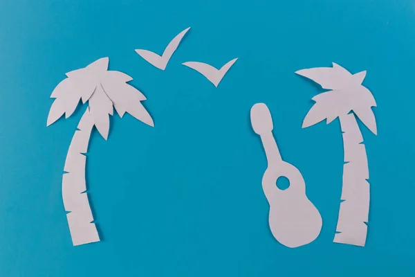 guitar on the beach In the summer. paper cut