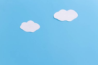 white clouds painted on blue bacground