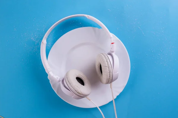 white headphones on the blue background