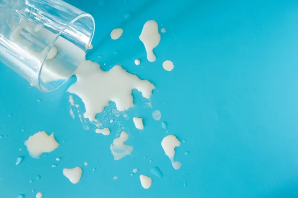 Salpicos de leite no fundo azul — Fotografia de Stock