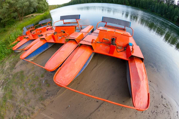 Old orange catamaran on lake — Stock Photo, Image