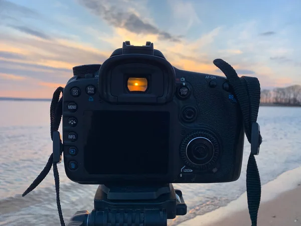 SLR camera on sunset background. Photography concept