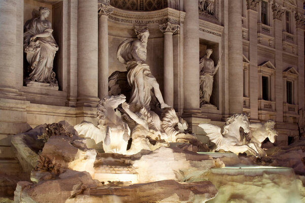 View of Fontana Di Trevi at night in Rome. Aqueduct-fed rococo fountain, designed by Nicola Salvi & completed in 1762, with sculpted figures.