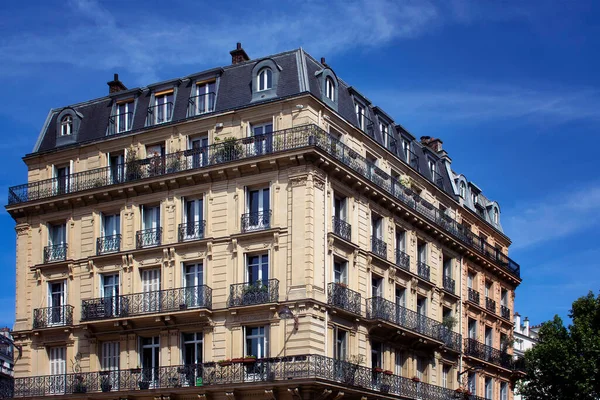 View of a traditional, historical building in Paris showing Parisian / French architectural style. It is a sunny day in spring. 3rd arrondissement