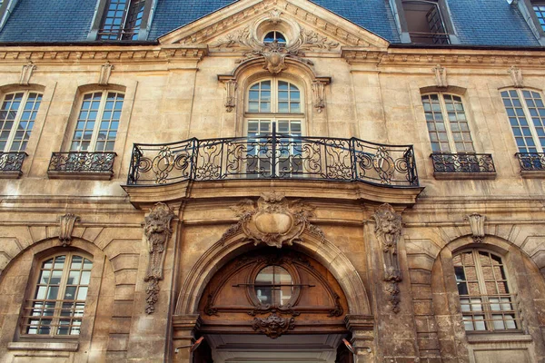 View of a traditional, historical building in Paris showing Parisian / French architectural style. It is a sunny day in spring. 3rd arrondissement