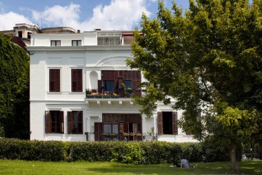 Tanınmayan bir çift, güneşli bir yaz gününün tadını çıkarıyor. İstanbul 'un Moda semtinde, Asyalı tarafında beyaz, eski bir evin gölgesinde..