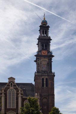 Amsterdam 'daki tarihi Westerkerk kilisesi manzarası. 85 metre yüksekliğinde kulesi olan 17. yüzyıl yapısı. Rembrandt 'ın gömülü olduğu Rönesans dönemi Protestan kilisesinden taç tepeli bir kule yükseliyor..
