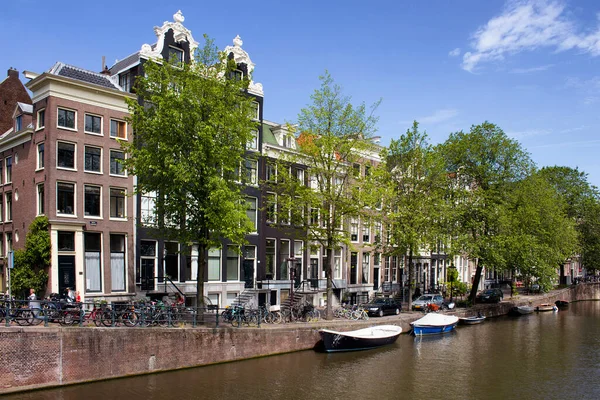 駐車船 自転車や車 アムステルダムのオランダの建築様式を示す歴史的 伝統的な建物の眺め 澄んだ青空が広がる晴れた夏の日です — ストック写真