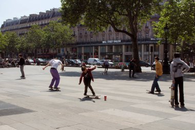 Gençler Paris 'teki Cumhuriyet Meydanı' nda (Place de la Republique) kayıyorlar. Görüntü şehrin gençlik kültürünü gösteriyor..