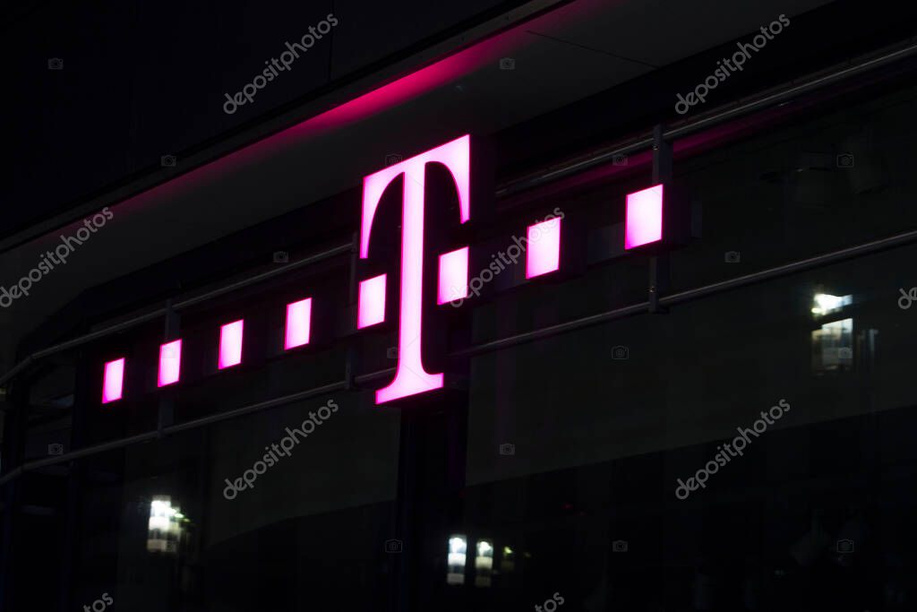 Night view of signage of a famous, international telecommunication brand's store in Frankfurt.
