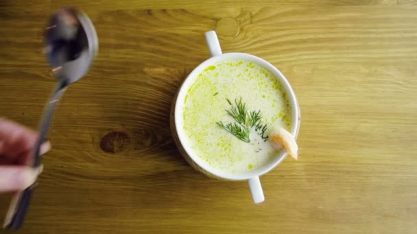 A womans hand putting a table spoon next to a plate of seafood soup. 4K — Stock Footage A womans hand putting a table spoon next to a plate of seafood soup. 4K Video Clip
