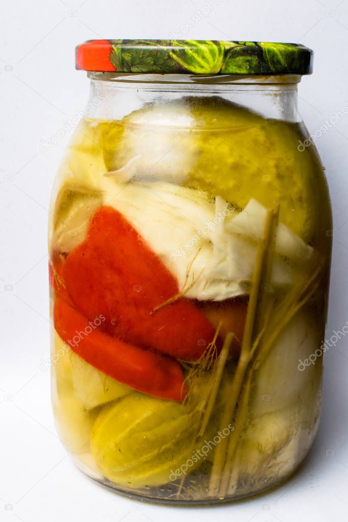 Jars with pickles, green cucumber, red pepper, mixed vegetables